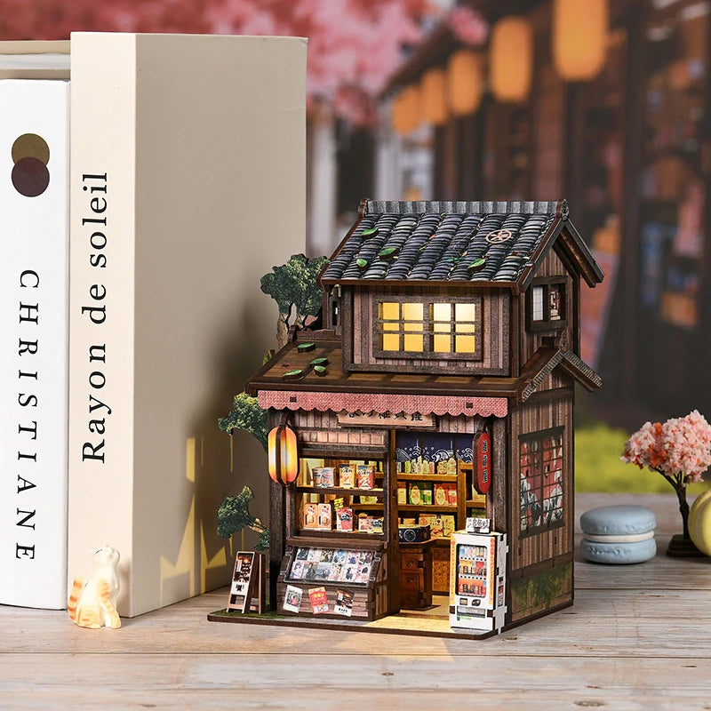 Zakoya grocery store book nook displayed between books on a shelf as bookshelf decor