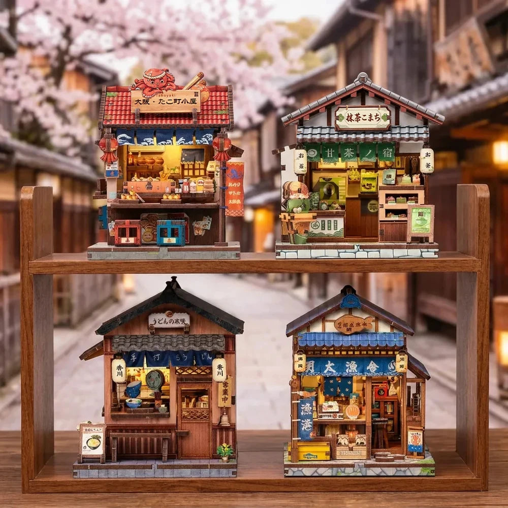 All four Japanese street shop book nook designs displayed together on wooden shelves