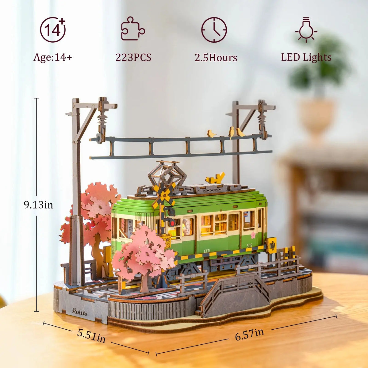 Assembled Sakura Journey Tram miniature model in warm LED light