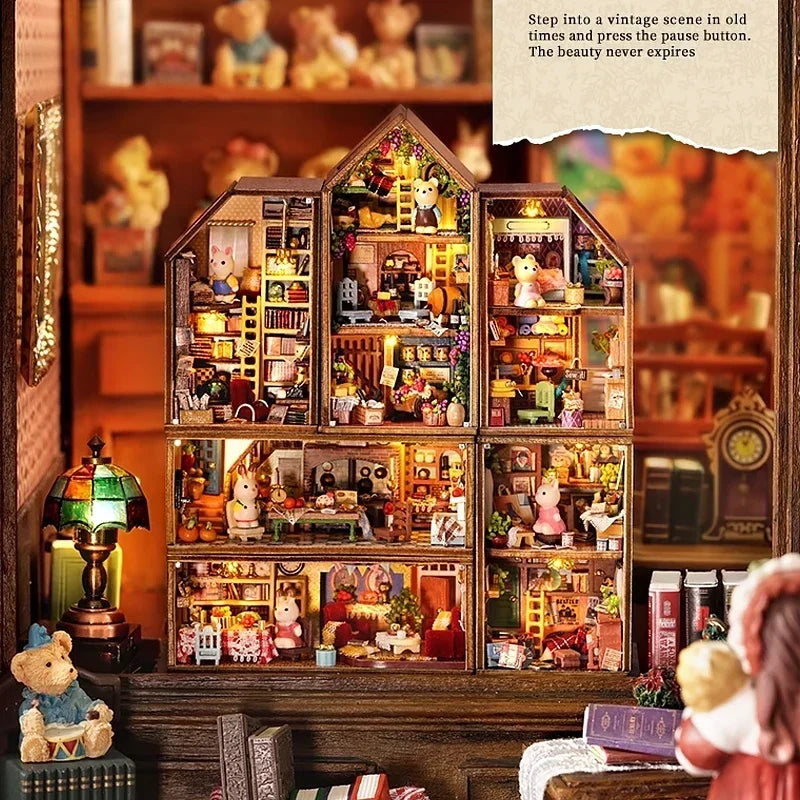 Full miniature dollhouse collection displayed on bookshelf with warm lighting