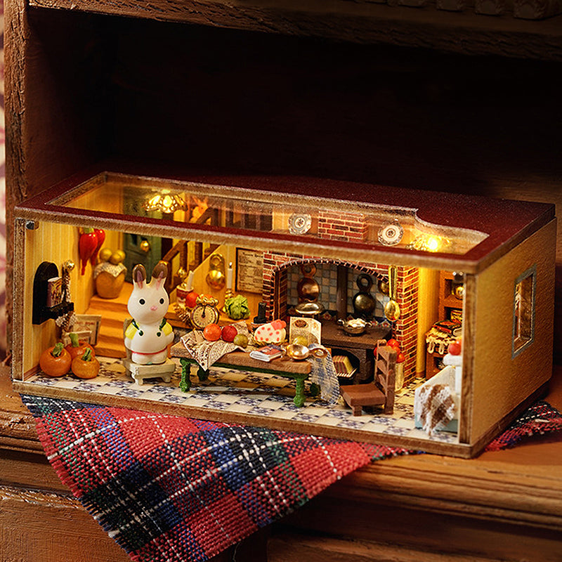 Miniature dollhouse model in cozy scene with plaid blanket