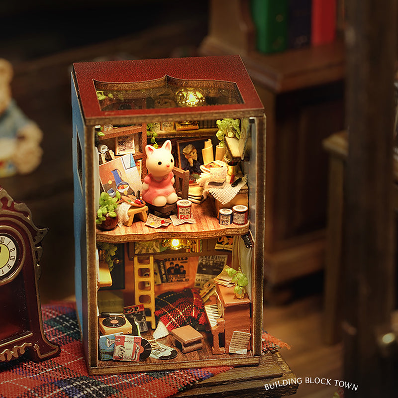 Miniature dollhouse displayed in glass display case