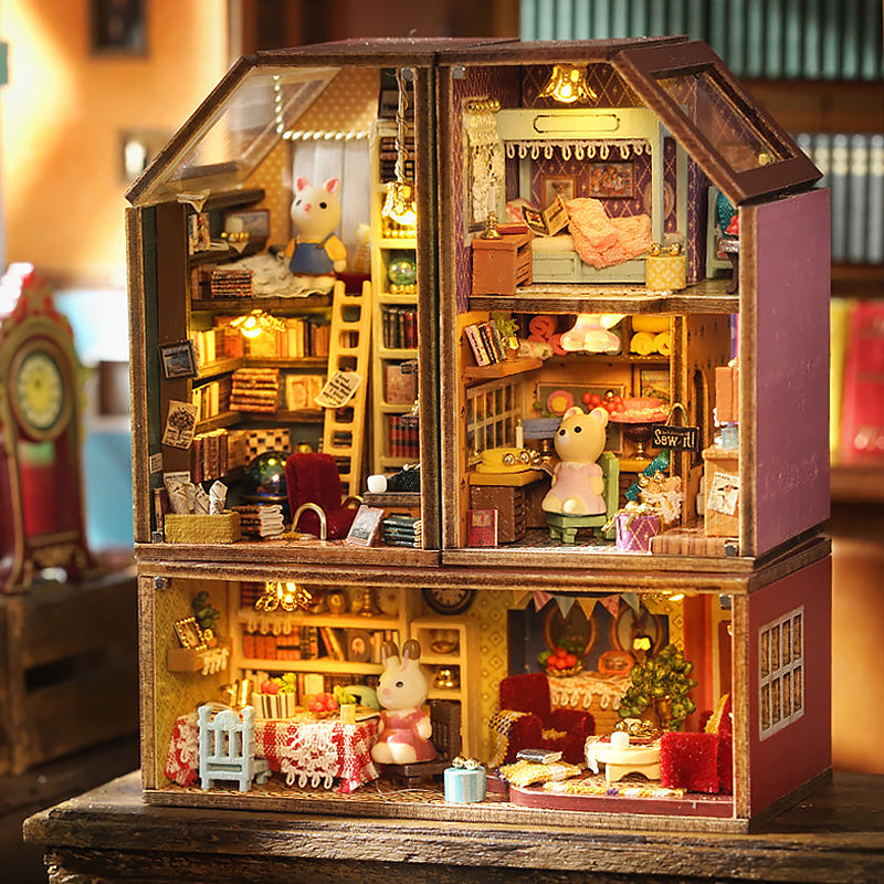 Assembled miniature dollhouse model with warm interior lighting