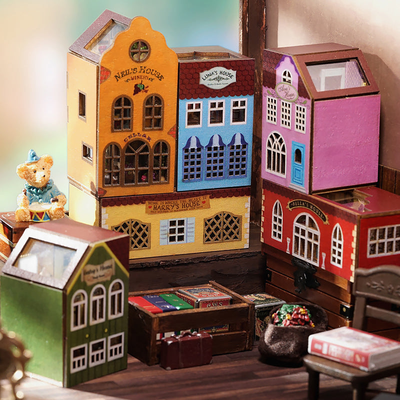 Multiple colorful miniature dollhouse models arranged as a scene